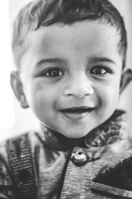 Close-up portrait of a child smiling confidently during a professional portfolio shoot.