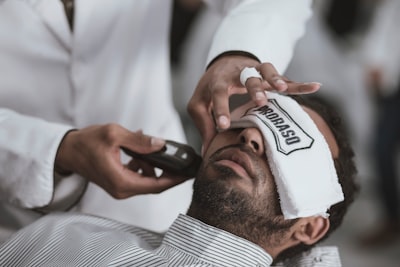 man shaving lying man trimming teams background