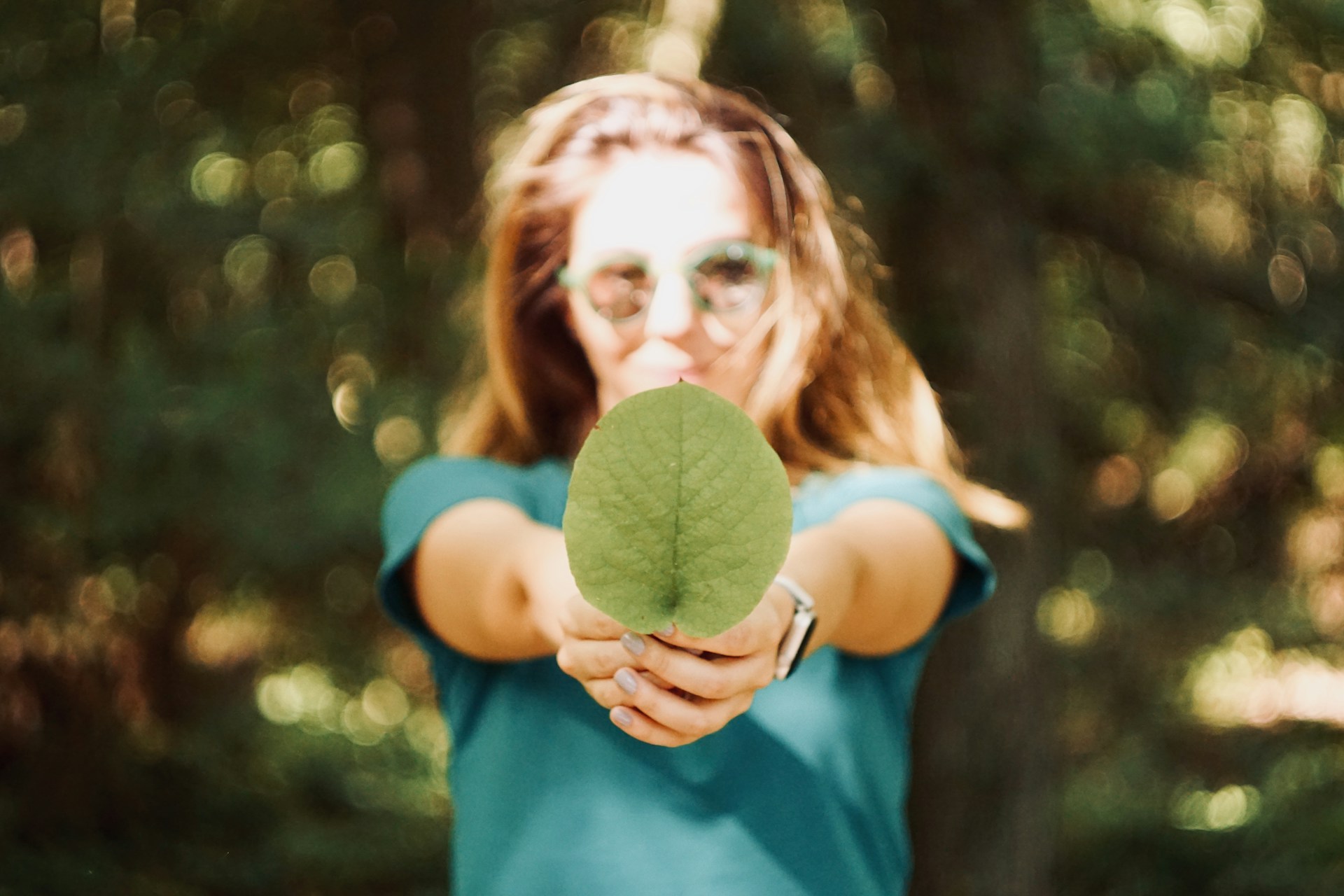 woman holding leaf