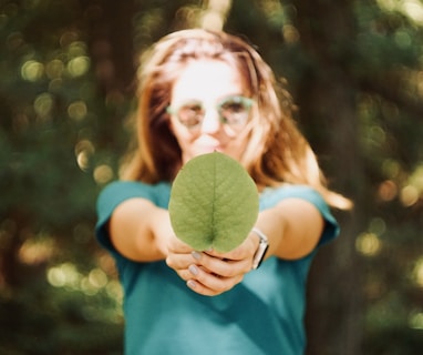 woman holding leaf