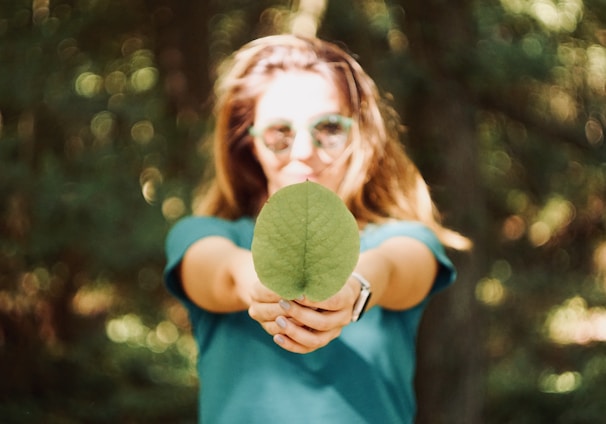 woman holding leaf