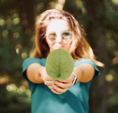 woman holding leaf