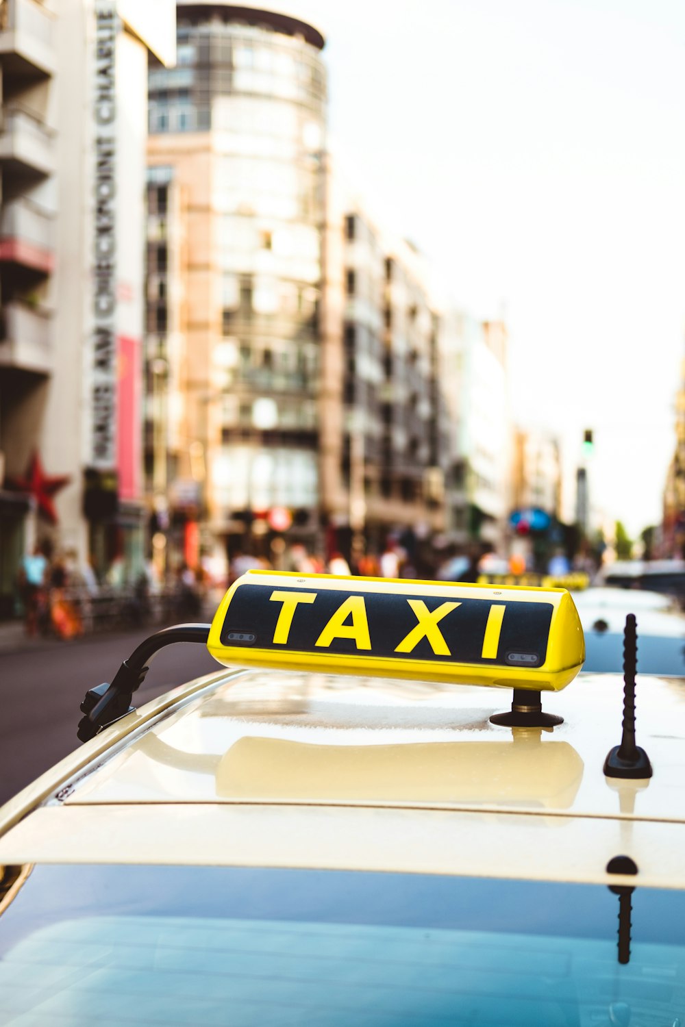 selective focus photo of yellow taxi LED signage