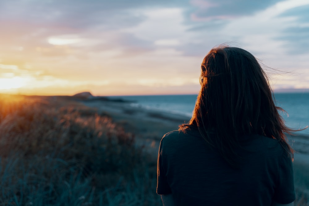 woman looking on body of water