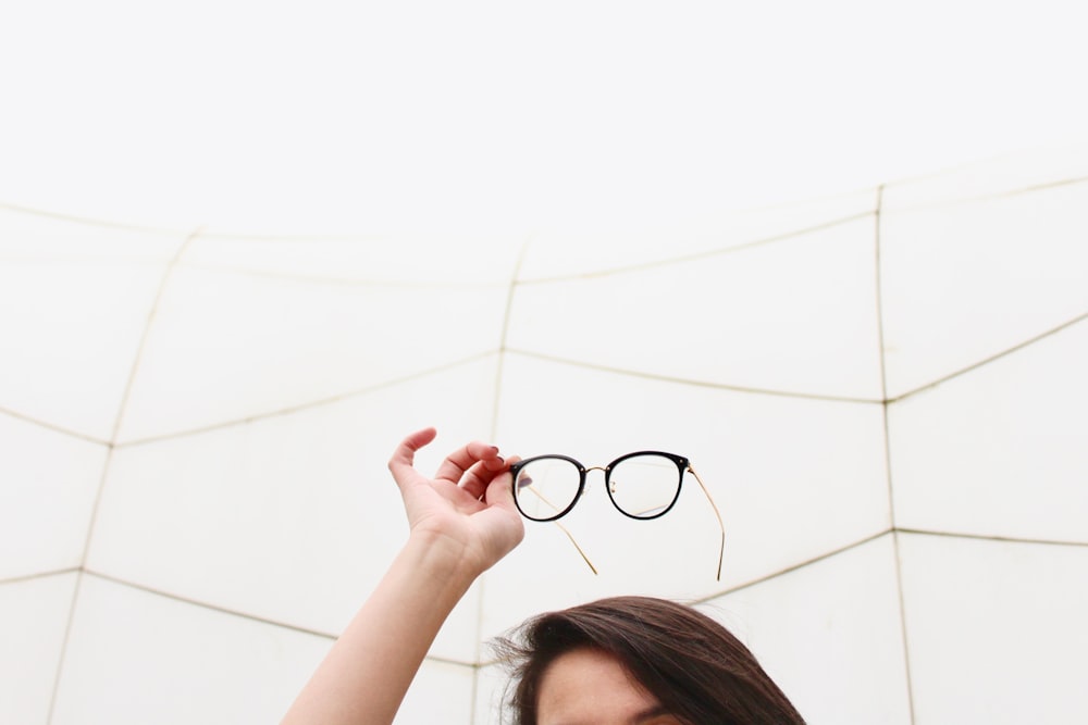 Person mit schwarz gerahmter Brille