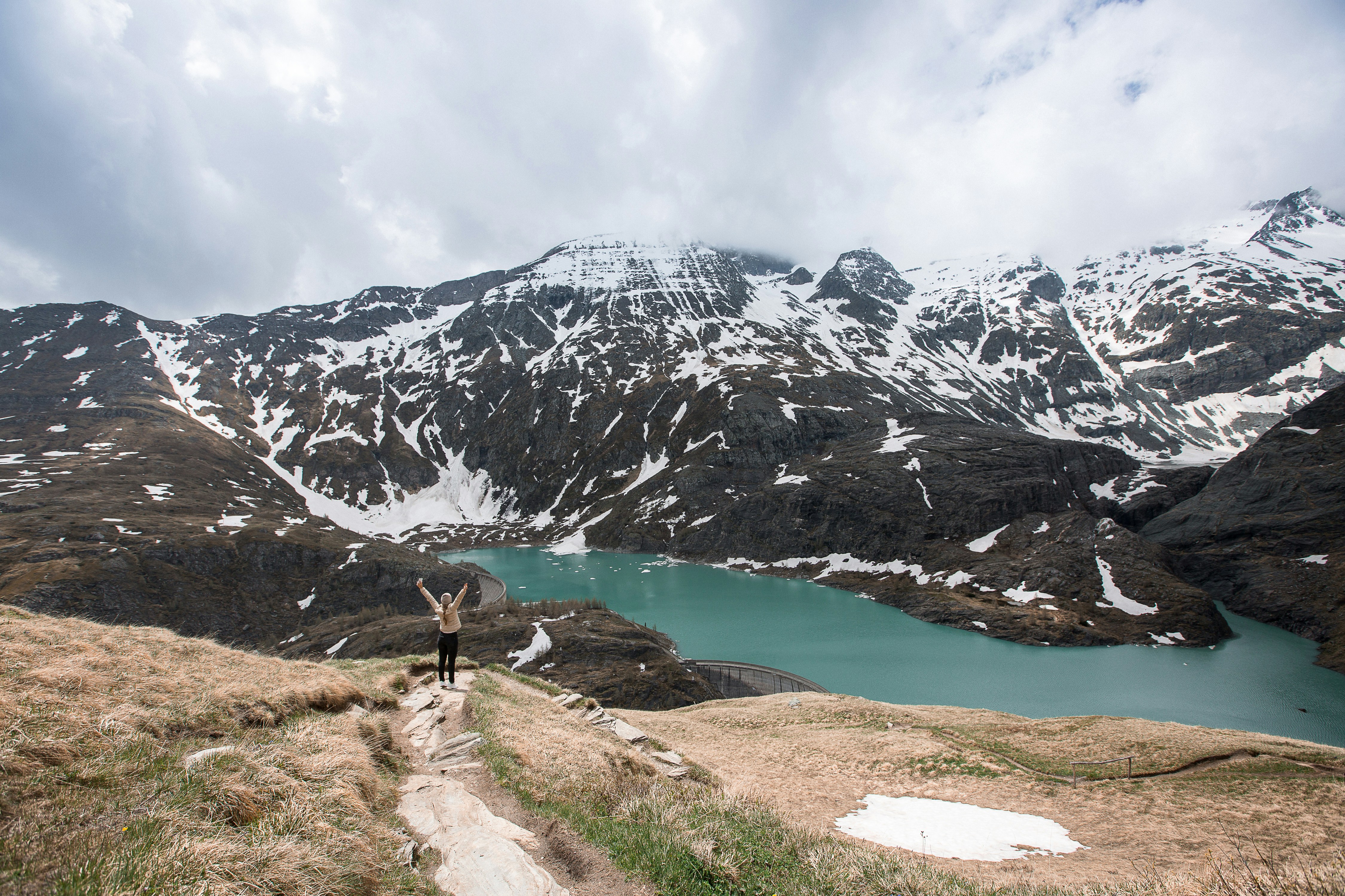 woman standing on mountain cliff