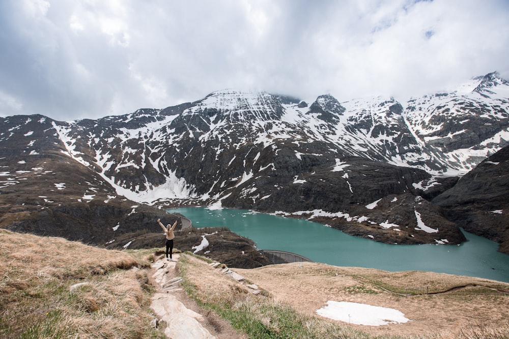 woman standing on mountain cliff