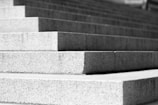A clean construction site with concrete steps being installed.