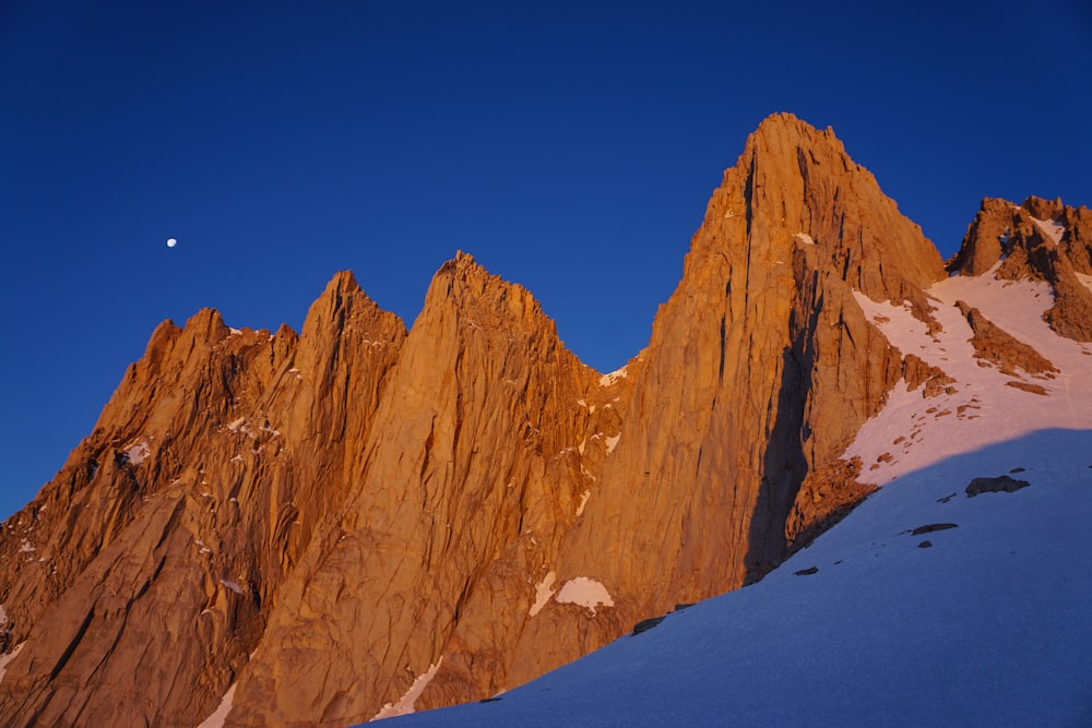 low-angle photography of brown rock mountain