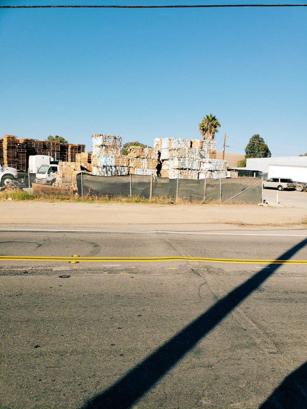 brown and white boxes beside wide road