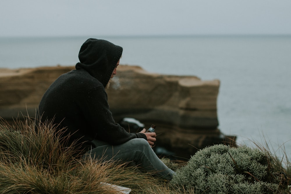 man facing body of water