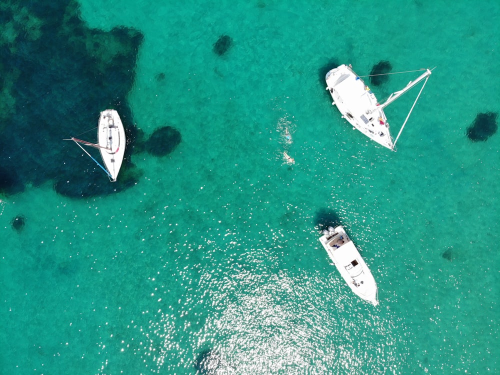 Vista aérea de três barcos brancos na água