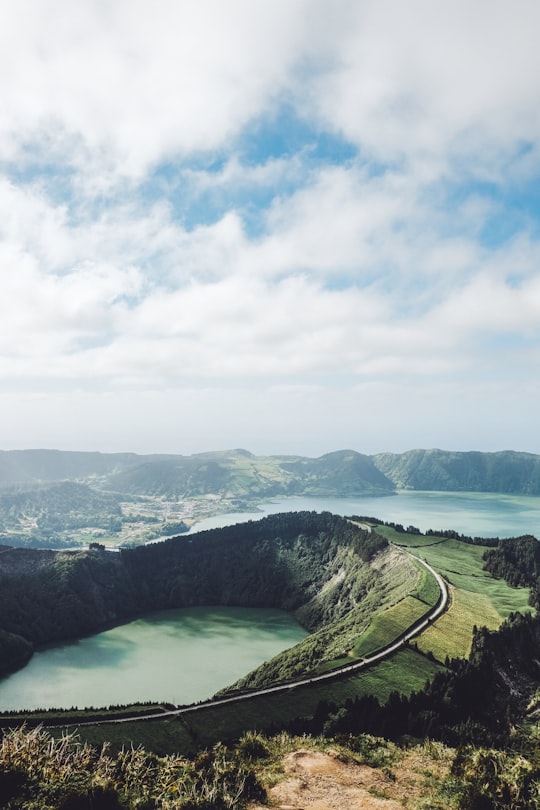 bird's-eye view of mountain under cloudy sky in Miradouro da Boca do Inferno Portugal