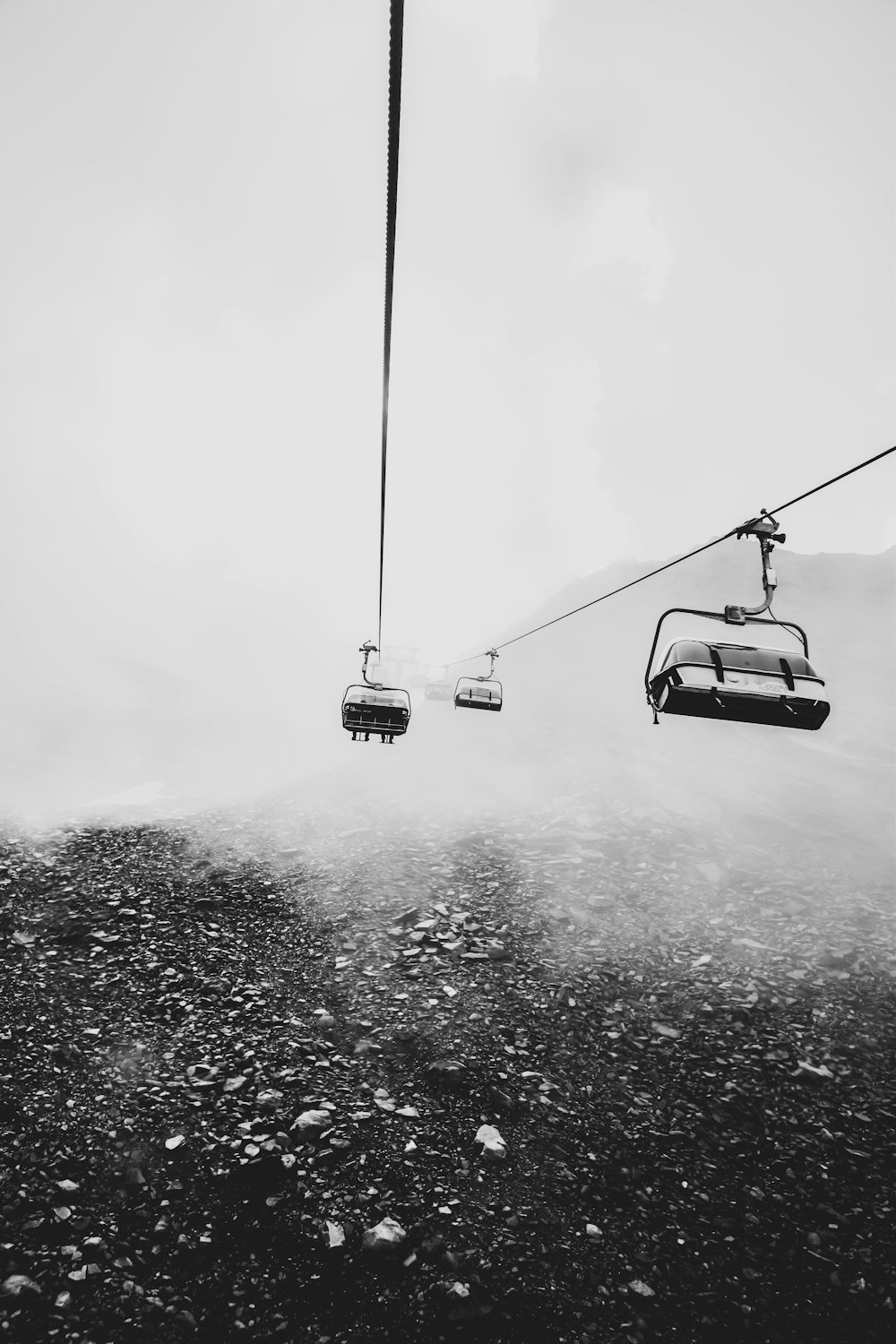 grayscale photography of cable cars