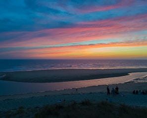 A vibrant group of travelers enjoying a sunset at a famous Mexican beach