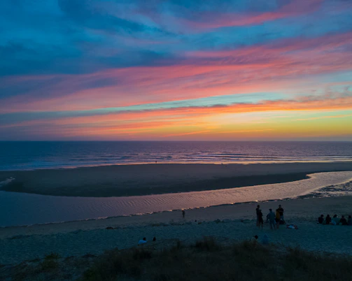 A vibrant beach sunset with travelers enjoying the view, capturing the essence of a perfect getaway.