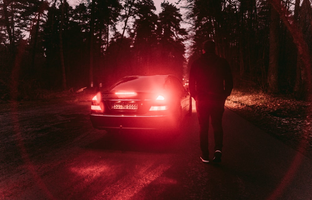 person standing near black car