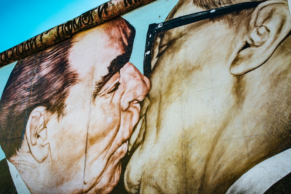 man and woman kissing painting