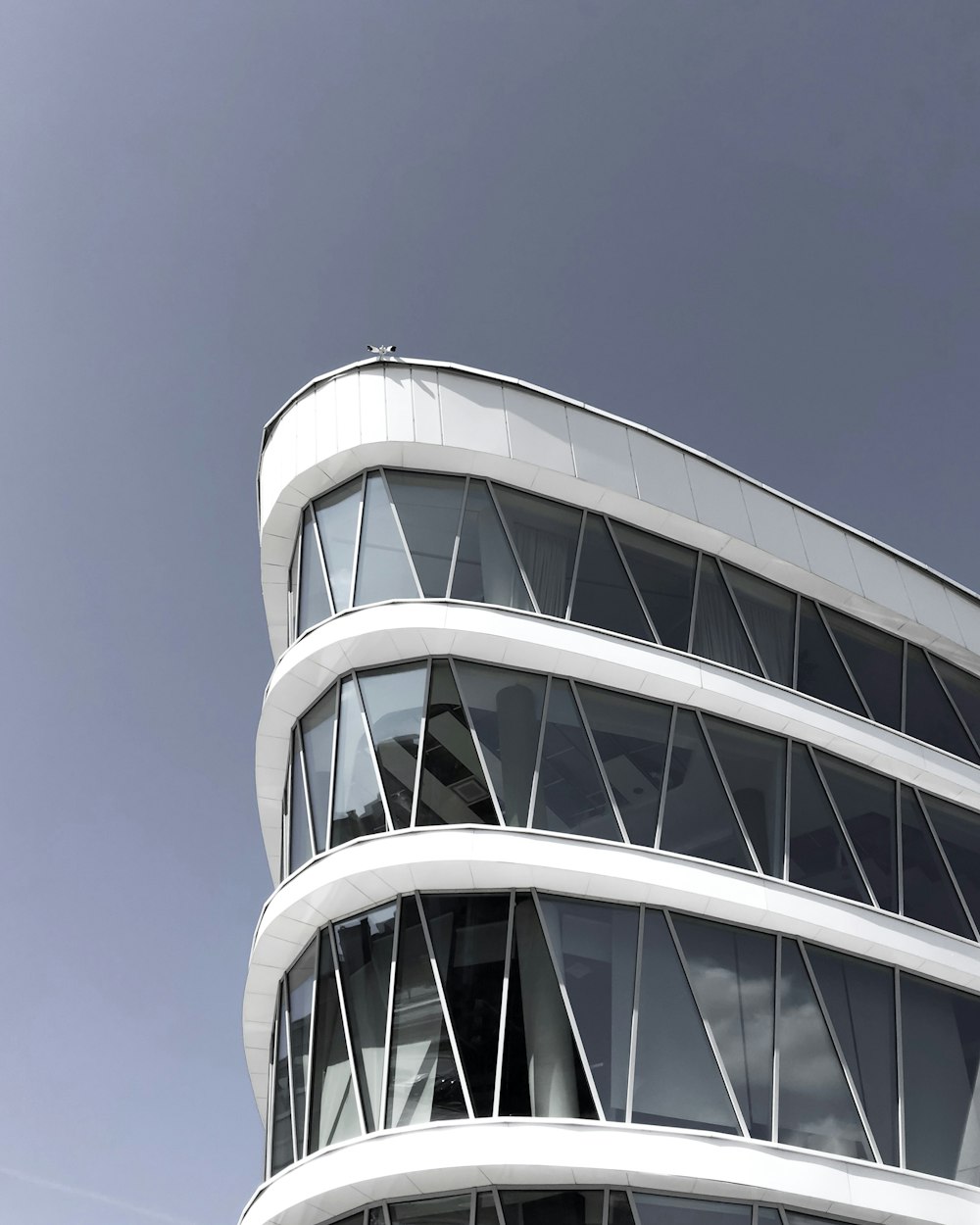 architectural photography of a white triangular building