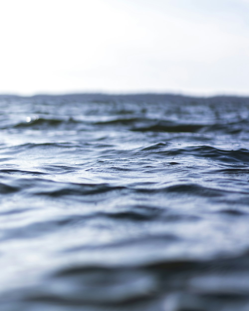 body of water under cloudy sky