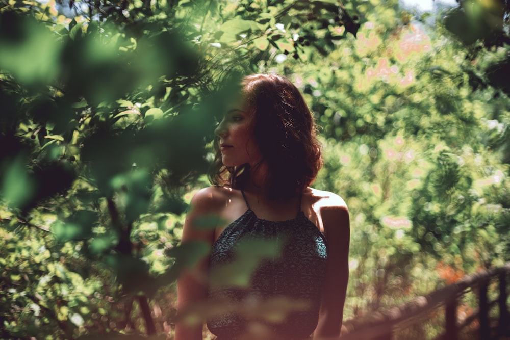 woman wearing halter top beside green tree