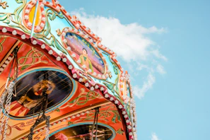 Charming pastel carousel horses spinning under a warm baby blue sky