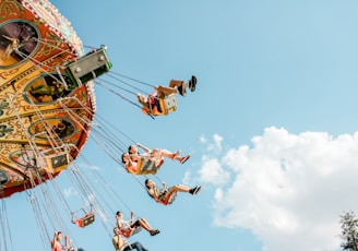 people riding on amusement rides at daytime