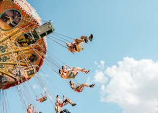 people riding on amusement rides at daytime