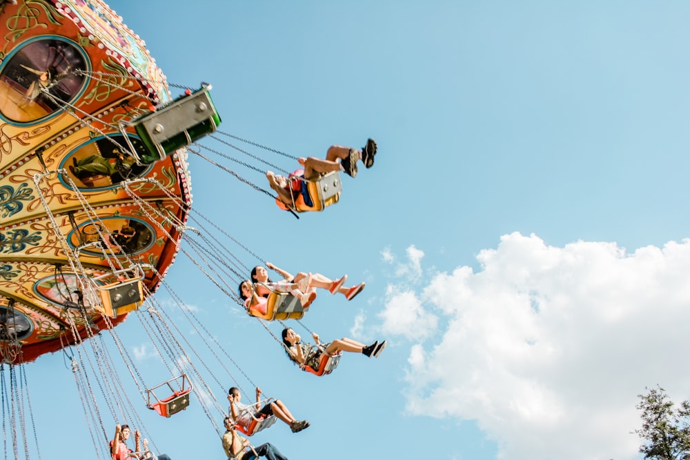 people riding on amusement rides at daytime