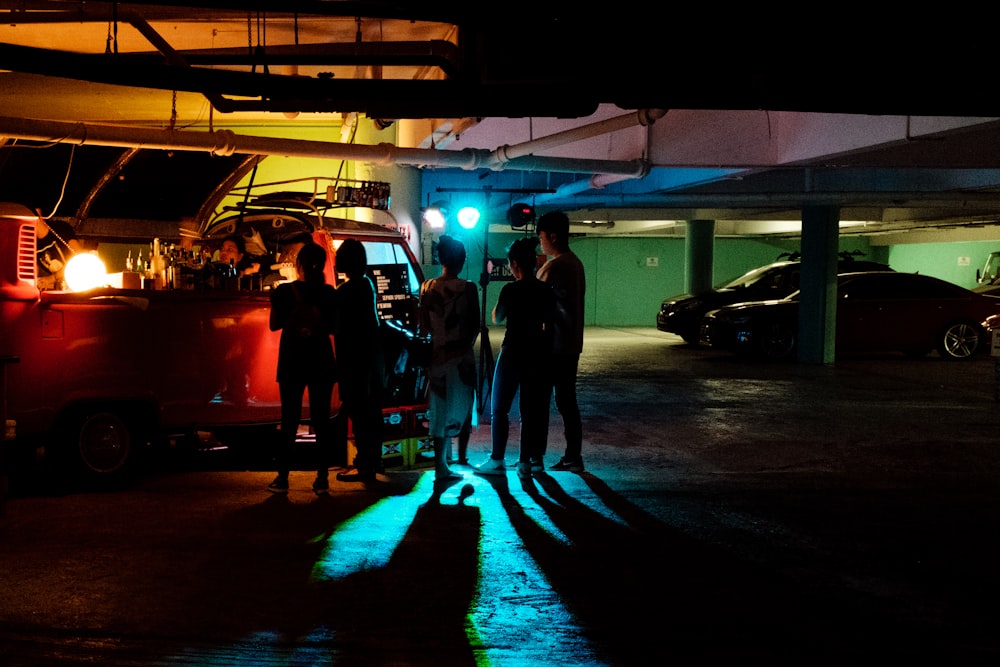 five person standing near vehicle at garage