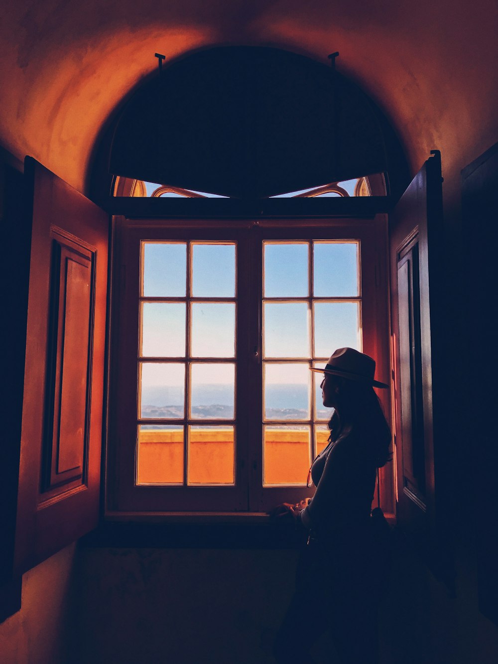 woman standing beside window