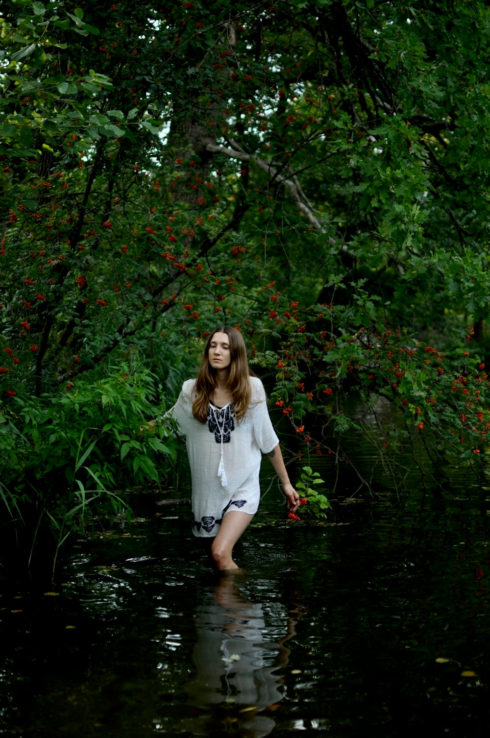 woman in white and black elbow-sleeved dress in body of water photography