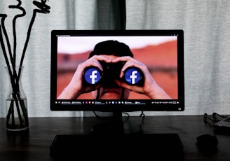 television showing man using binoculars