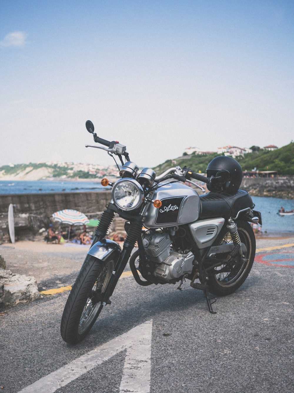 gray standard motorcycle parked far away from body of water