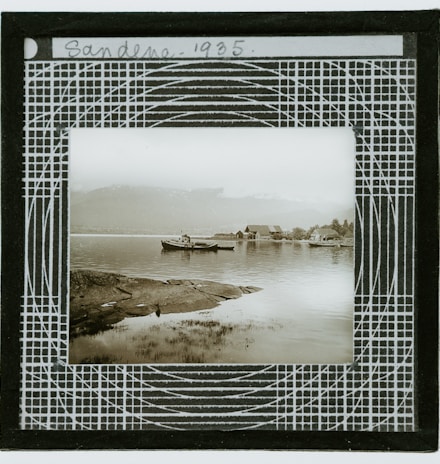 white and black boat on body of water