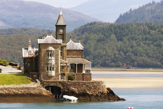 castle near body of water in Wales United Kingdom