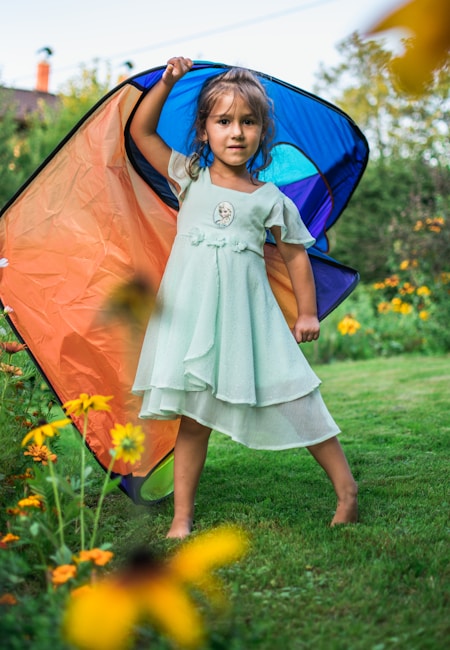 photo of girl holding tent