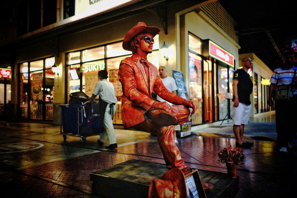 man wearing sunglasses statue near store