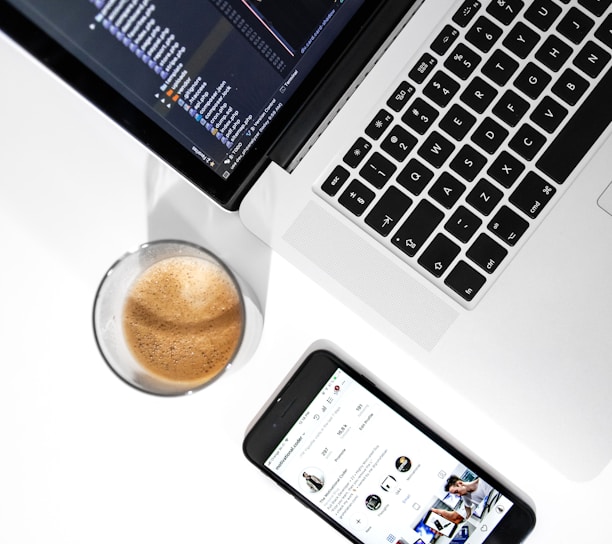 MacBook Pro near space gray iPhone 6 on white wooden table