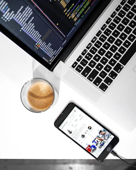 A cozy workspace with a laptop displaying AI code and a cup of coffee nearby.