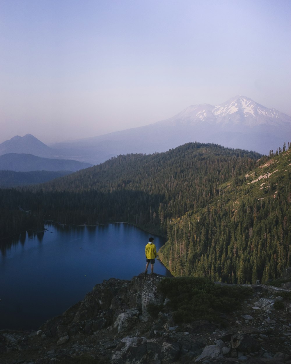 person standing on rock facing Mount Fuji, Japan