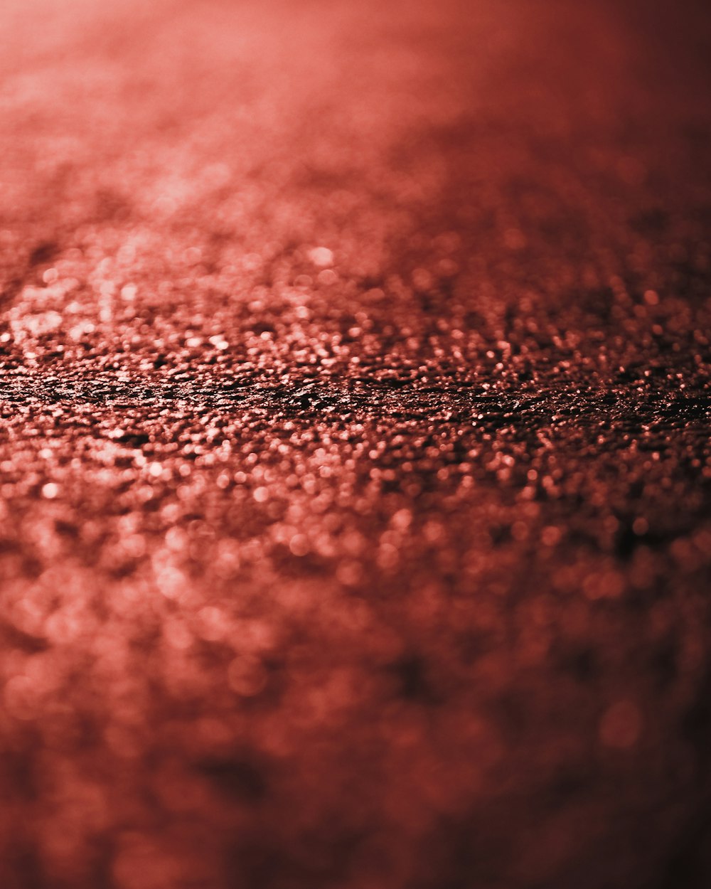 a close up of a red surface with a blurry background