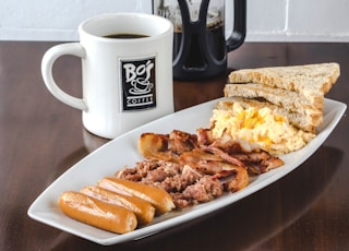 bread and bacon platter beside French press