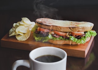 toasted bread with sliced tomatoes and coffee