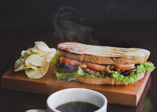 toasted bread with sliced tomatoes and coffee