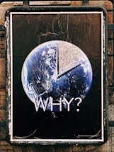 A poster featuring the Earth with a large portion removed, revealing a dry, cracked surface. The word 'WHY?' is prominently displayed underneath, suggesting a message about environmental concerns, such as climate change or deforestation. The image contrasts the planet’s vibrant blue and white colors against a stark brown, emphasizing the theme of environmental degradation.