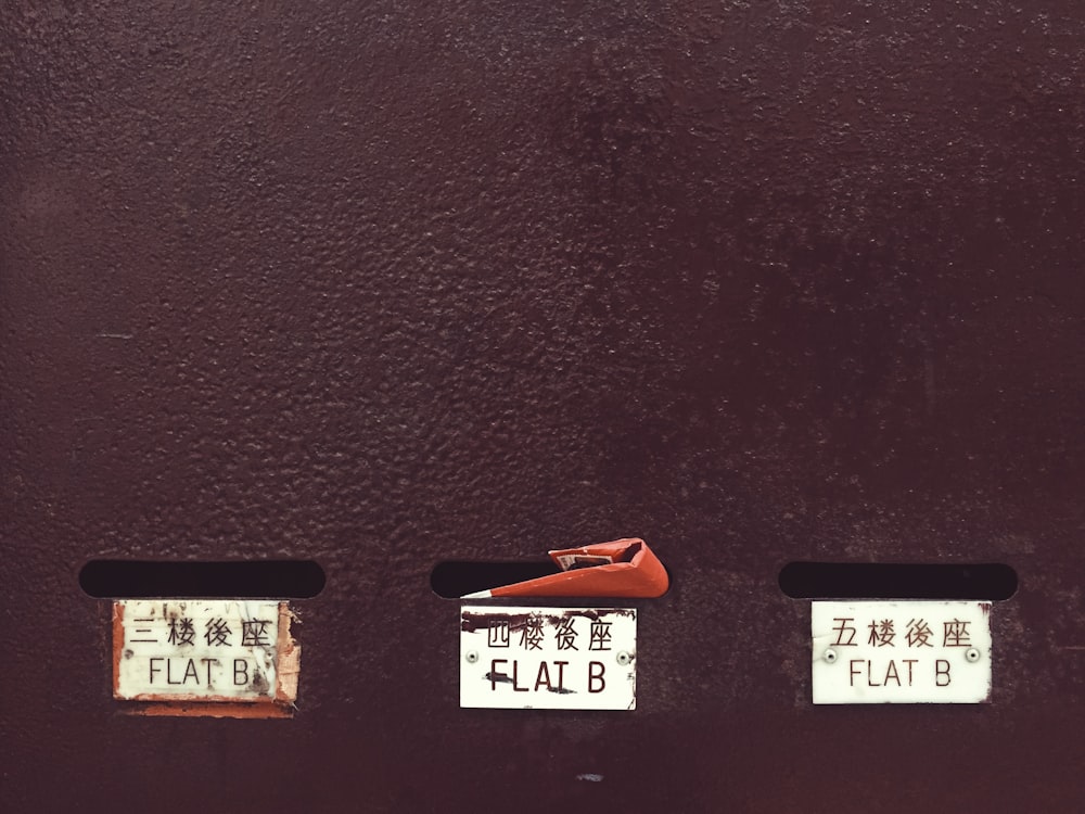 a close up of a red door with a pair of scissors