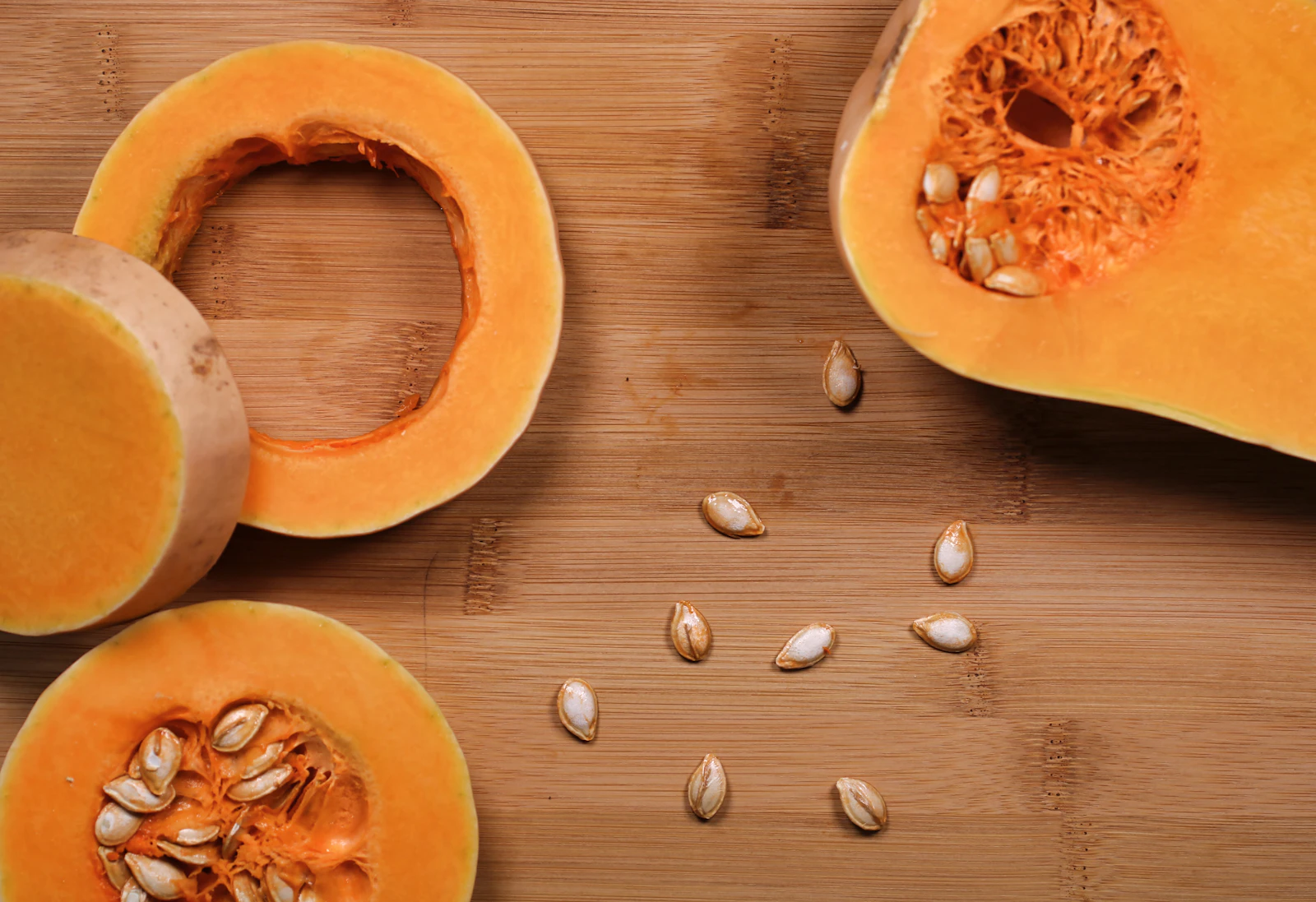 A sliced pumpkin on a wooden surface
