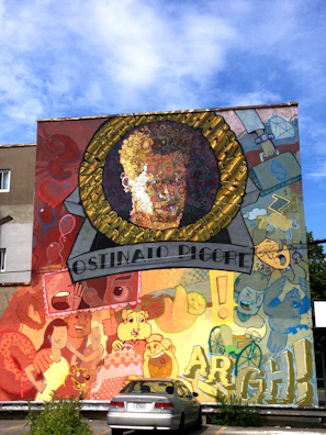 Artistic mural featuring Ruzzo MC's iconic logo and cultural symbols.