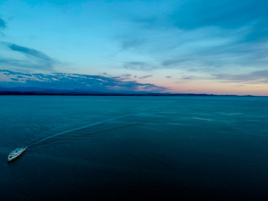 white speedboat on body of water in Neuchâtel Switzerland